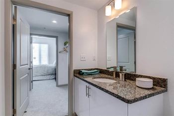 a bathroom with a sink and a large mirrorat East 51 At Rocketts Landing, Richmond, VA